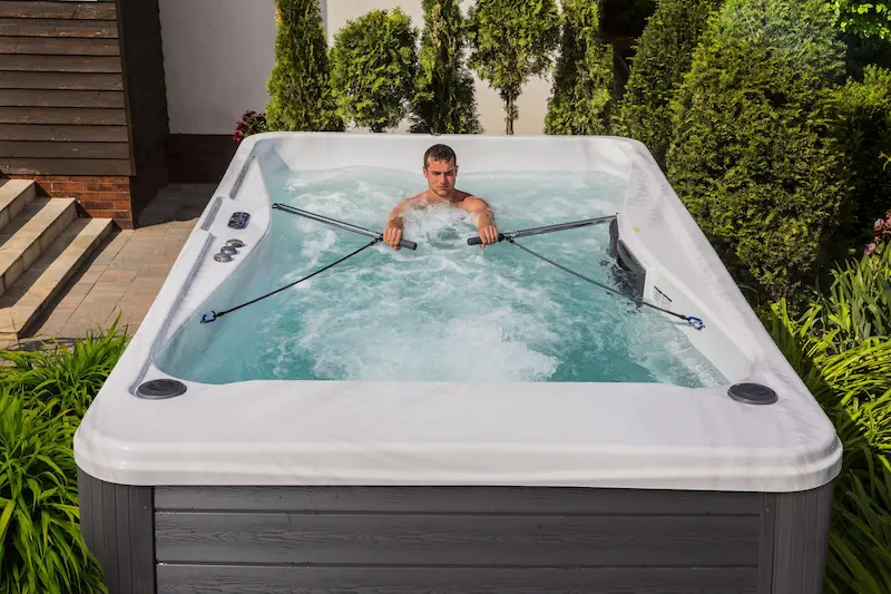 The Best Exercise Spas & Swim Spa Equipment 1 Picture of a person working out in exercise spas.