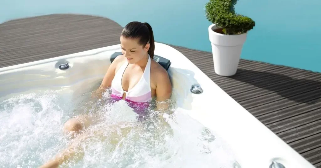 Do Hot Tubs Help Sore Muscles? 1 Person soaking in a hot tub after reading, "Do Hot Tubs Help Sore Muscles?"