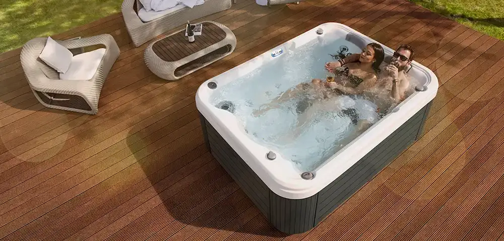 What Is a Lounger Hot Tub? 1 Picture of people relaxing in a lounger hot tub.