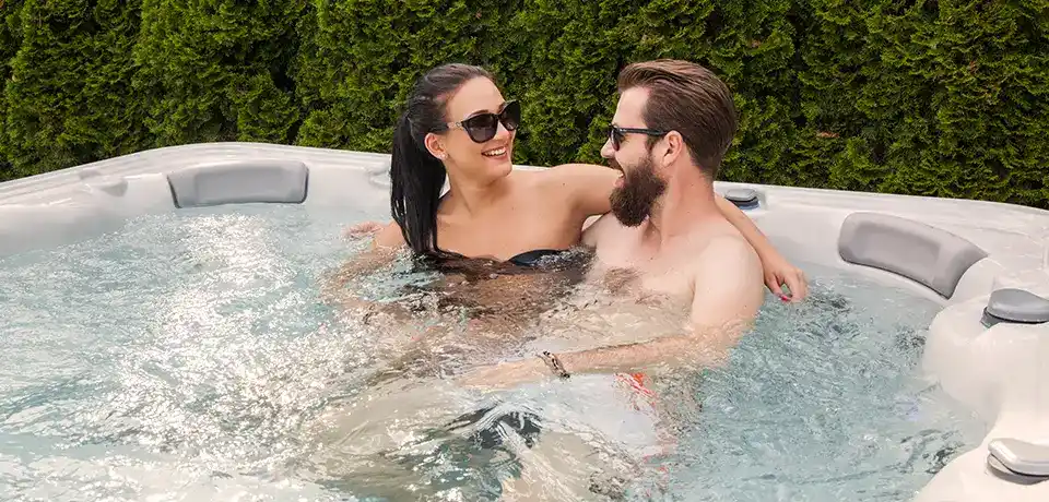 Explore Compact Luxury: The Smallest Hot Tub For Sale 1 A couple sitting in the smallest hot tub for sale