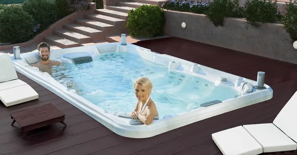 Trending Backyard Design Ideas for 2024 2 Picture of people in a swim spa for the blog about backyard design ideas.