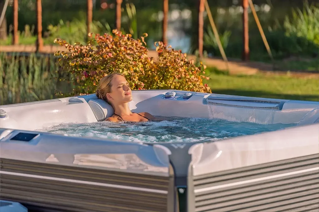 Woman relaxing in the largest hot tub for sale at Wellis Spa