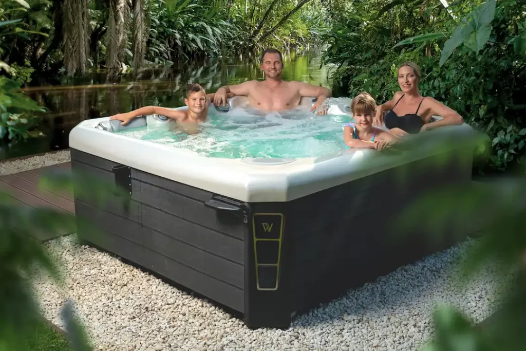 Picture of a family soaking in a hot tub after reading, "Are hot tubs good for you," article.