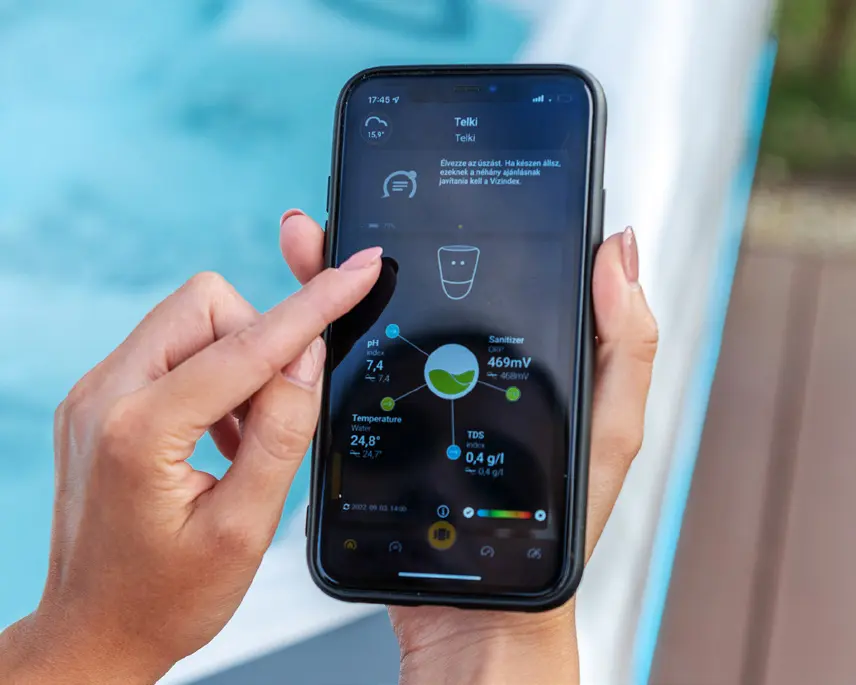 Picture of a person holding a mobile device pairing Bluetooth on a luxury hot tub.