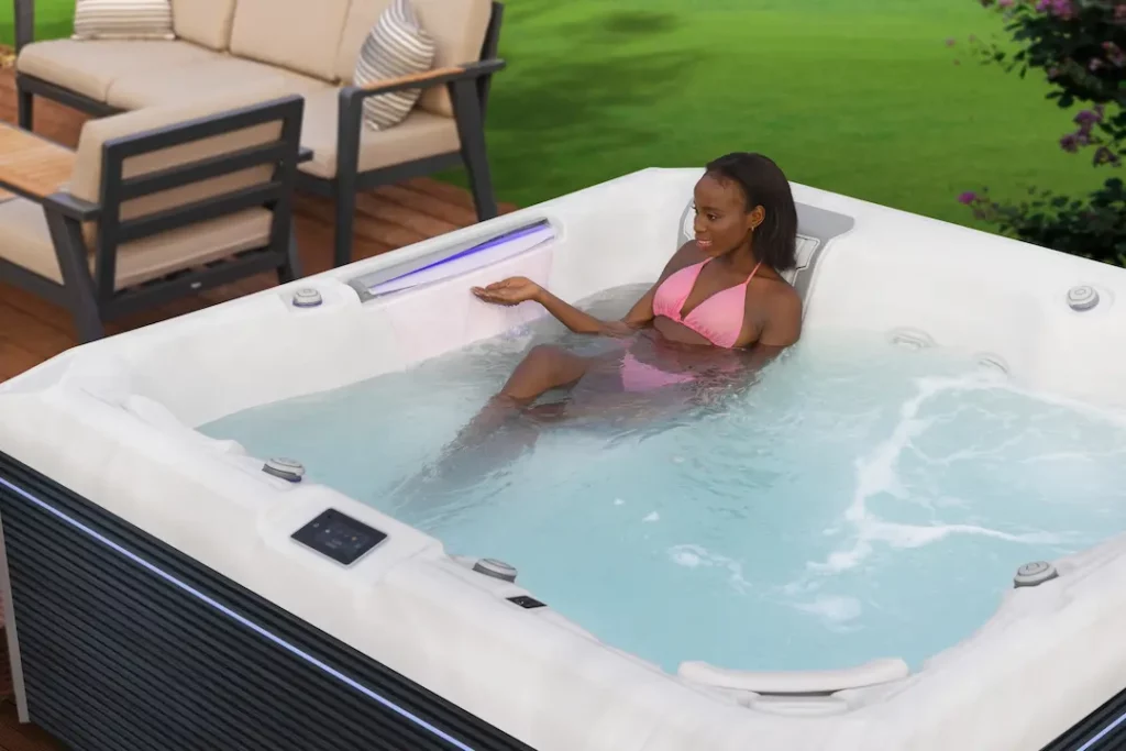 A woman relaxing in a hot tub after learning about the top home renovation ideas.