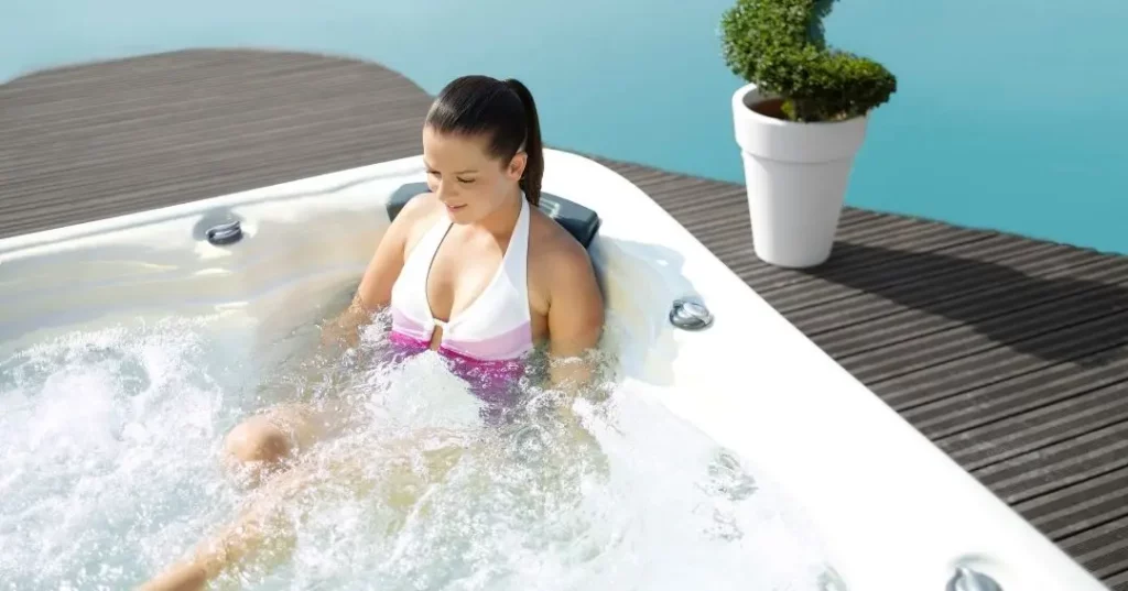 women in a hot tub after surgery, aiding her recovery process