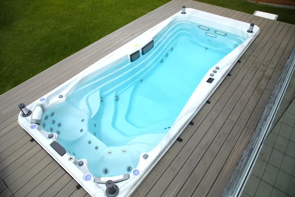 Home renovation ideas that show a swim spa installed in a deck.
