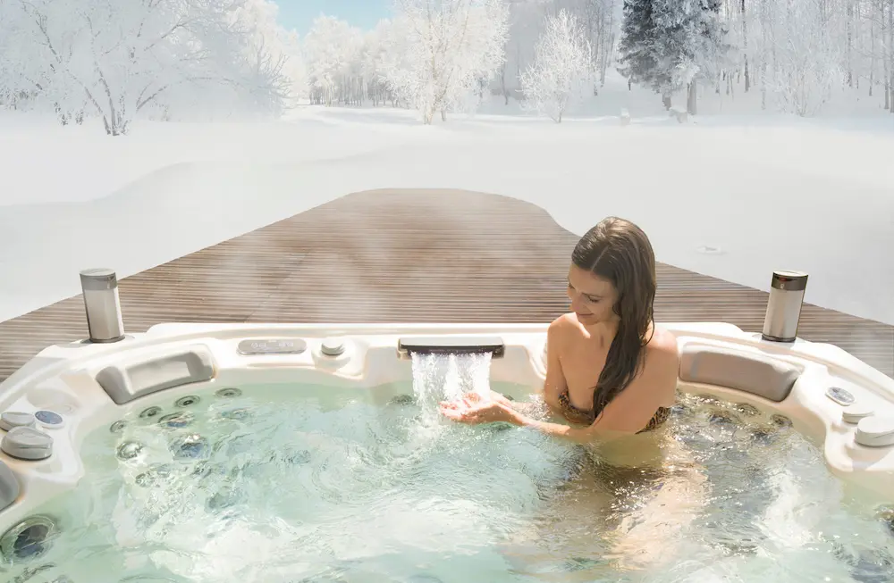 Picture of a woman using the best winter hot tub accessories.